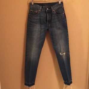 Worn look frayed blue jeans
